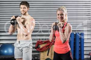 Couple lifting dumbbells together