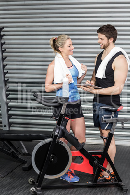 Smiling fit couple taking notes