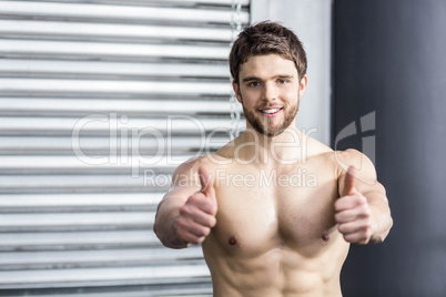 Shirtless fit man with thumbs up