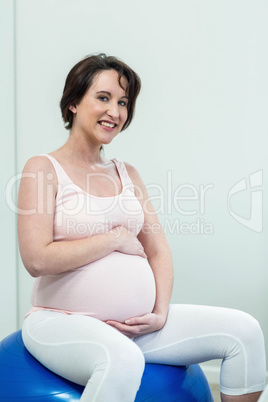 Pregnant woman sitting on exercise ball