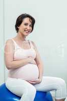 Pregnant woman sitting on exercise ball