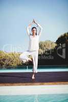 Calm brunette doing yoga