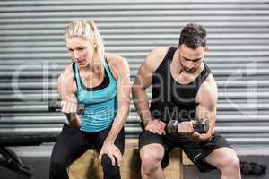 Couple lifting dumbbells together