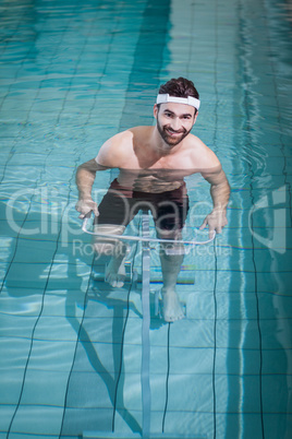 Smiling man doing underwater bike