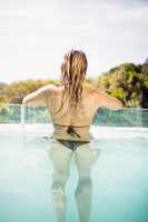 Rear view of blonde in the pool