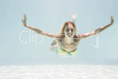 Fit woman swimming under water