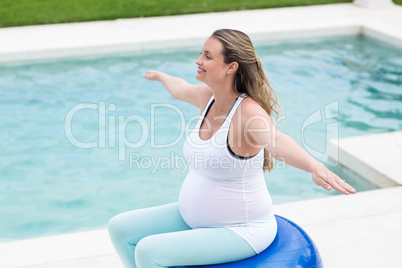 Pregnant woman sitting on exercise ball