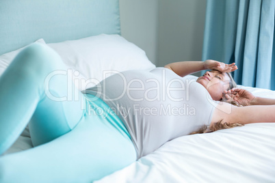 Pregnant woman lying on her bed