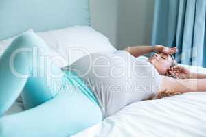 Pregnant woman lying on her bed
