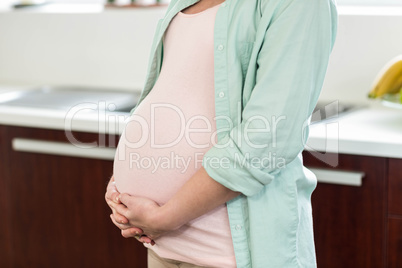 Pregnant woman touching her belly