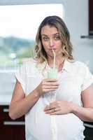 Pregnant woman drinking a smoothie