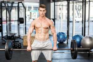 Fit man lifting barbell