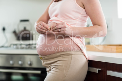 Pregnant woman destroying cigarette