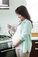 Pregnant woman holding glass of water