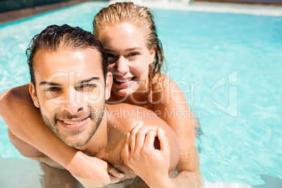 Happy couple embracing in the pool