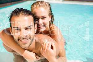 Happy couple embracing in the pool