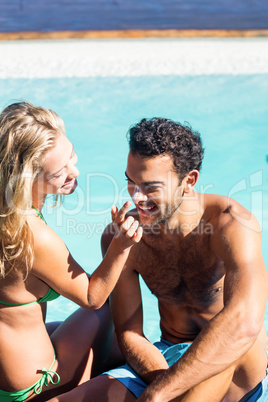 Girlfriend applying cream to boyfriend