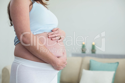 Pregnant woman touching her belly