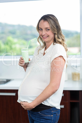 Pregnant woman drinking a smoothie