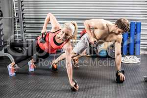 Couple doing push up with dumbbells