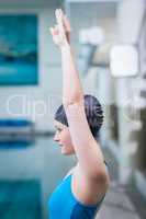 Fit woman raising arms