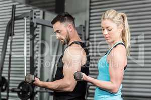 Couple posing with dumbbells