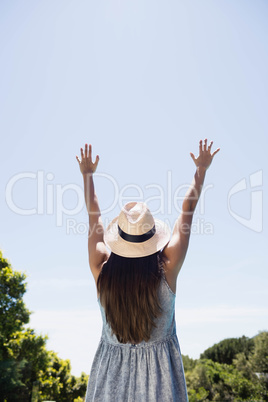 Rear view of brunette raising hands