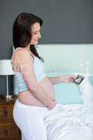 Pregnant woman looking at ultrasound scans