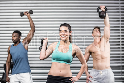 Fit people lifting dumbbells