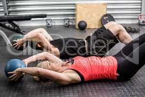 Fit couple doing abdominal ball exercise