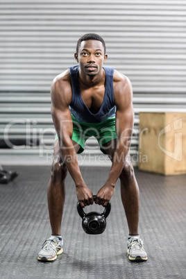 Portrait of fit man lifting dumbbells