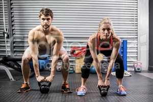 Couple lifting dumbbells together