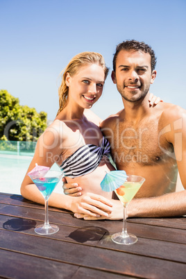 Happy couple embracing in the pool