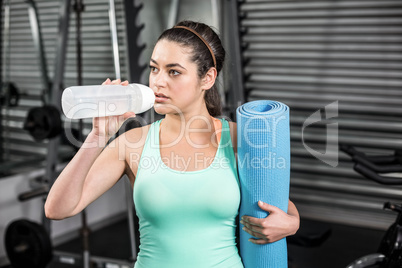 Athletic woman drinking water