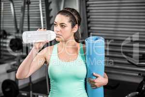 Athletic woman drinking water