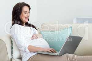 Pregnant woman resting on couch