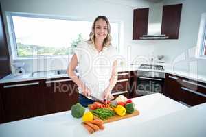 Pregnant woman cutting vegetables