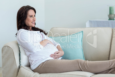 Pregnant woman resting on couch