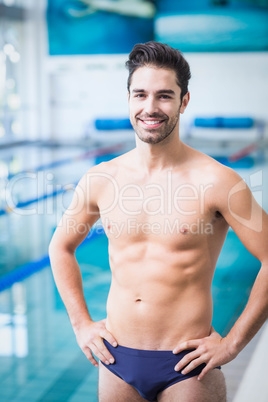 Handsome man standing with hands on hips