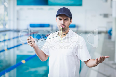 Angry trainer blowing whistle and holding stopwatch