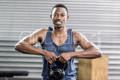 Portrait of fit man lifting dumbbells