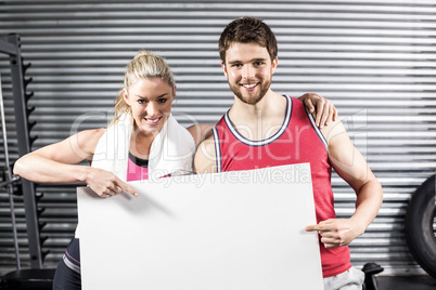 Fit couple holding blank paper