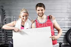 Fit couple holding blank paper
