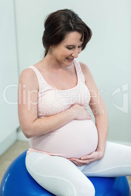 Pregnant woman sitting on exercise ball