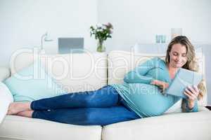 Pregnant woman using a tablet computer