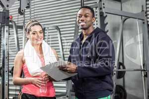 Trainer and woman looking at workout plan
