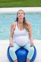 Pregnant woman sitting on exercise ball