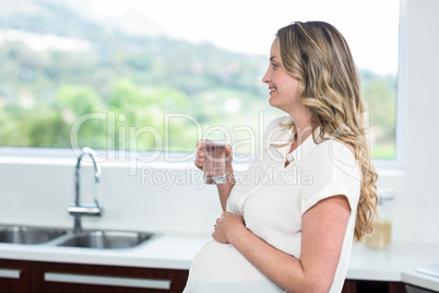 Pregnant woman drinking a glass of water