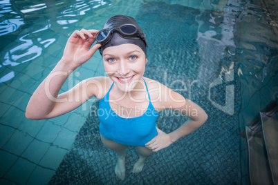 Fit woman wearing swim cap and goggles in the water