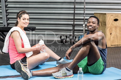 Smiling woman and man talking on sport towel